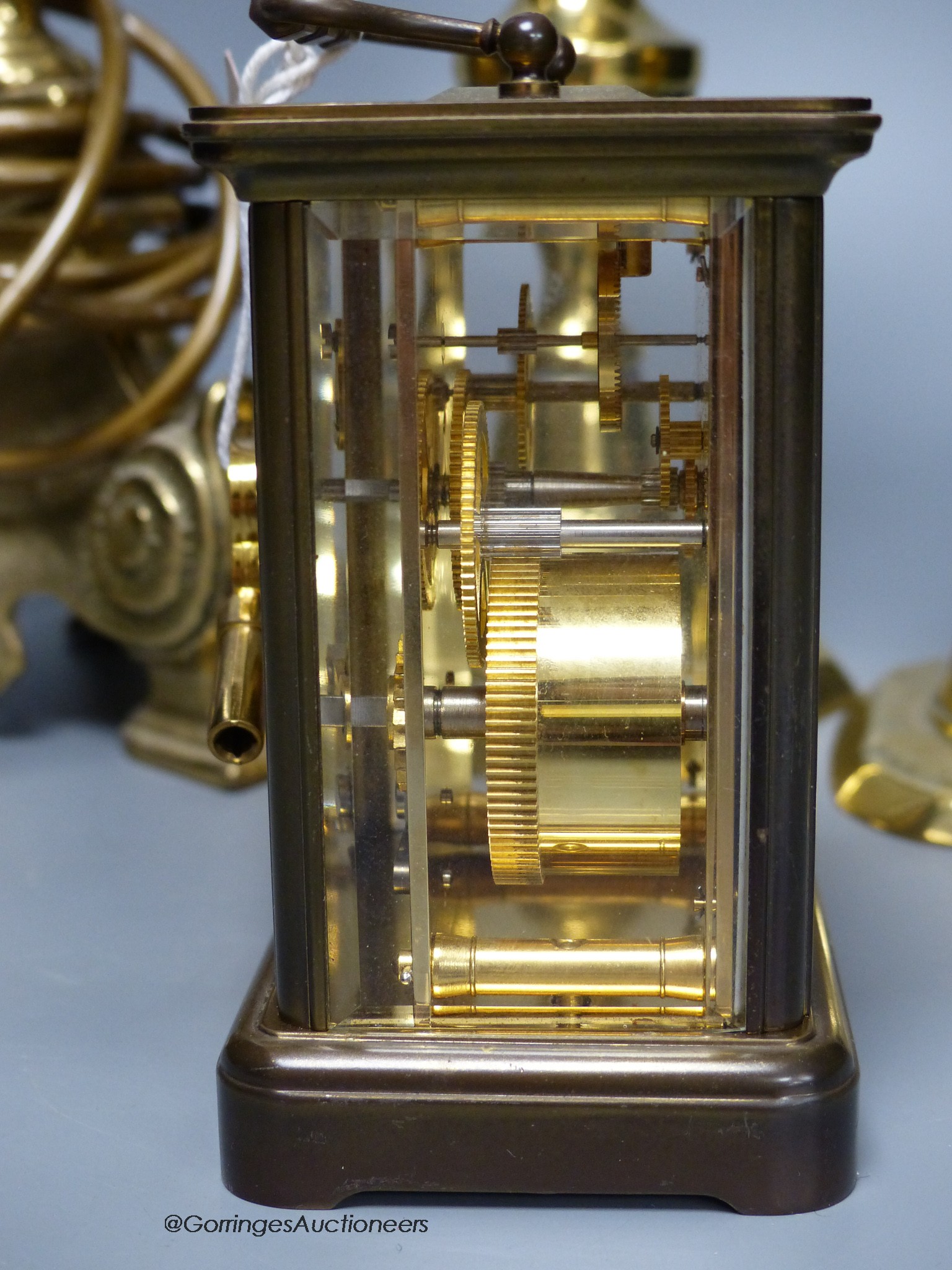 A Matthew Norman brass carriage clock, No.1754 together with a pair of brass candlesticks and a table lamp